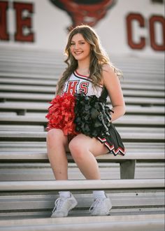 a cheerleader is sitting on the bleachers and posing for a photo with her pom poms