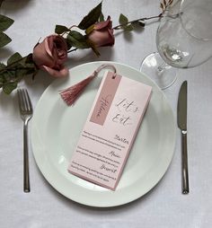 a white plate topped with a pink menu