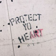 graffiti on the side of a building that says protect you heart