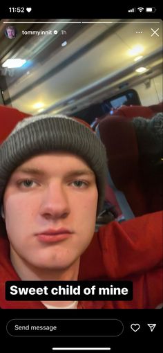 a young man wearing a beanie and looking at the camera