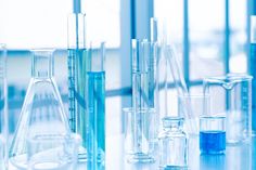 laboratory glassware filled with blue liquid on a table