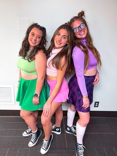 three girls are posing for the camera with their arms around each other while wearing matching outfits