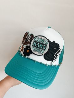 This custom made trucker patch hat is perfect for any occasion whether it be for spring/summer time, a lake hat, a gift for someone, or just a cute accessory to add a little spice to your outfit 🧢✨ DETAILS-  * This hat is one size with an adjustable SnapBack that is adjustable from 20in. - 23.5in. * The color of this hat is Turquoise & White * The material of the hat is polyester with iron on patches  REFUNDS AND CANCELLATIONS- Every hat is handmade by me as a result, a slight variation can occ Adjustable Baseball Cap With Patches For Summer, White Patches Hat For Summer, Adjustable White Hat With Patches, Green Trucker Hat For The Beach, Green Trucker Hat For Beach, Spring Cap With Patches, Summer Trucker Hat With Embroidered Patch, Green Trucker Hat For Festivals, Trucker Hats With Patches Diy