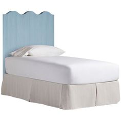 a bed with a blue headboard and white sheets on it's bottom half