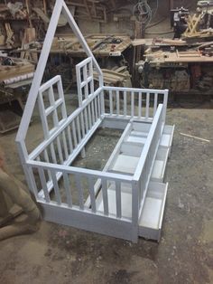 an unfinished dollhouse bed frame in the process of being built