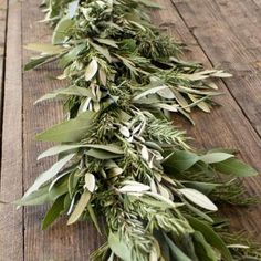 a bunch of green leaves on top of a wooden table