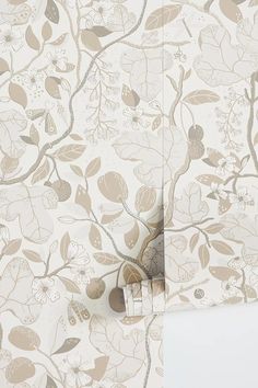 the wallpaper is decorated with flowers and leaves