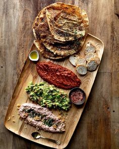 a wooden tray topped with different types of food