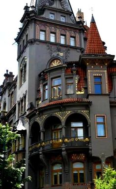 an ornate building with lots of windows on the top floor