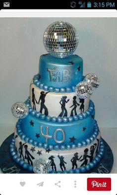 a three tiered birthday cake with disco balls on top and the words happy birthday to you