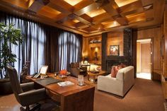 a living room filled with furniture and a fire place next to a window covered in curtains