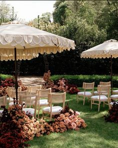 chairs and umbrellas are set up in the grass