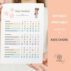 a person holding up a printable planner for kids