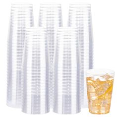 a bunch of glasses filled with ice cubes next to a glass full of lemonade