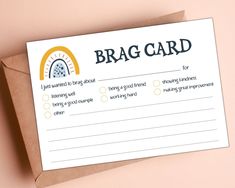 a brag card on top of a brown envelope