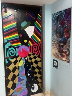 two paintings on the wall next to each other in front of a door with an abstract design painted on it