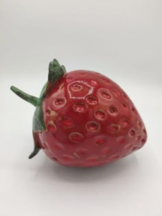 a close up of a strawberry on a white background