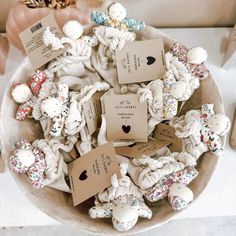 a bowl filled with lots of different types of candies on top of a table