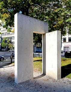 a concrete structure sitting in the middle of a park