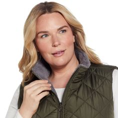 a woman wearing a green vest and white shirt