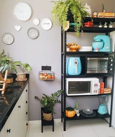 a kitchen filled with lots of different types of appliances and decor on the wall above it