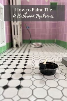 a bathroom with pink and green tiles and a black bowl on the floor in front of it