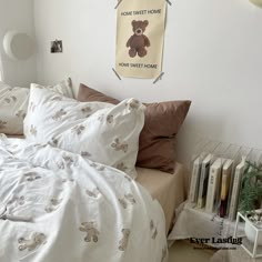 there is a bed with white sheets and brown pillow cases on the headboard in this bedroom