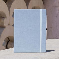 a blue book sitting on top of a cement slab