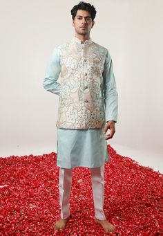 Cotton Silk Kurta in Pastel Blue. This Readymade Chinese Collar Neck and Full Sleeve attire is Enhanced with Fancy Buttons, Digital Print, Zari and Dori Work Available with a Cotton Silk Aligarhi Pant in White and an Art Silk Nehru Jacket in Pastel Blue Do note: Footwear shown in the image is for presentation purposes only. Half to one inch may vary in measurement. (Slight variation in actual color vs. image is possible) We sell all kinds of menswear. Mens Kurta | Mens Kurta Pajama | Mens Sherwa Elegant Blue Floral Print Kurta, Blue Sleeveless Kurta For Festive Occasions, Festive Sleeveless Blue Kurta, Festive Blue Sleeveless Kurta, Traditional Sleeveless Blue Kurta, Blue Cotton Nehru Jacket For Wedding, Blue Sleeveless Set For Festivals, Blue Cotton Nehru Jacket For Festive Occasions, Blue Fitted Kurta For Spring