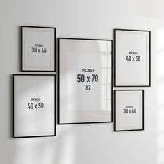 four black and white frames hanging on the wall