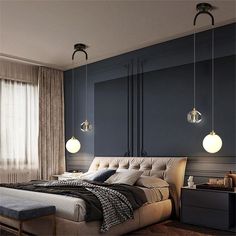 a large bed sitting under two hanging lights next to a window in a room with blue walls