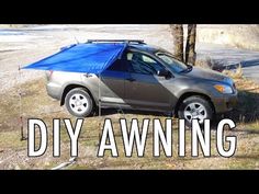 a car with a blue tarp on it parked next to a tree and the words diy awning