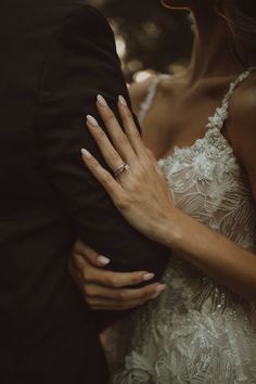 the bride and groom are embracing each other