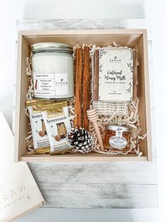 an open box containing honey, cinnamon sticks, and other items to make a gift