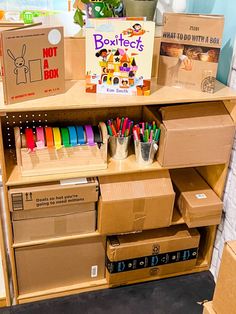 cardboard boxes are stacked on top of each other in front of a bookshelf