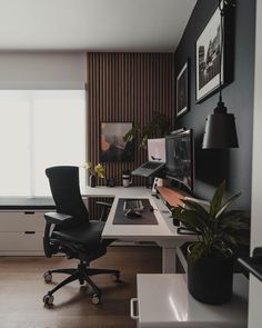 an office with black and white decor in the corner