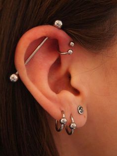 a woman with three piercings on her ear