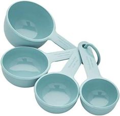 three blue measuring cups and spoons on a white background