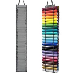 a rack with many different colored crayons hanging from it's side and another one in the background