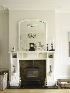 an image of a living room with fireplace and mirror