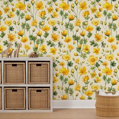 a room with yellow flowers on the wall and wicker baskets in front of it