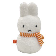 a white stuffed rabbit with an orange and white striped scarf