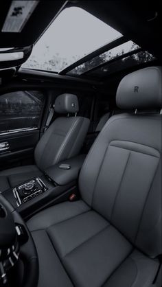 the interior of a car with black leather seats