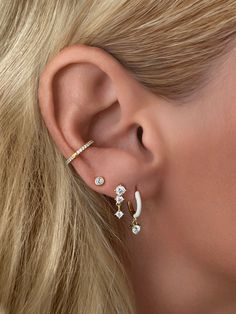 This dainty dangle stud earring features two prong set stones and one dangle prong set stone. Perfect for layering & stacking. A great beginner dangle style if you're new to drop earrings.Size: 12.5mm Stone: Cubic ZirconiaMaterials: Sterling Silver & 14K Gold Vermeil Pretty Ear Piercings, Earrings Stone, Gold Bond, Earring Trends, Earring Bundle, Pearl Collection, Summer White, Cz Stud Earrings, Vermeil Jewelry