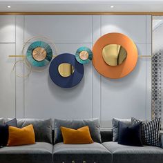 a living room with three circular mirrors on the wall and two couches in front of it