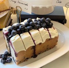 a slice of cake on a plate with blueberries