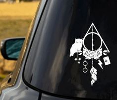 a car with an owl and dream catcher sticker on it