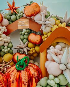 an artistic display of pumpkins, grapes and other fruits