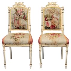 a pair of chairs with floral designs on them