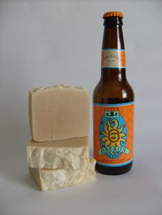 a bottle of beer next to a bar of soap